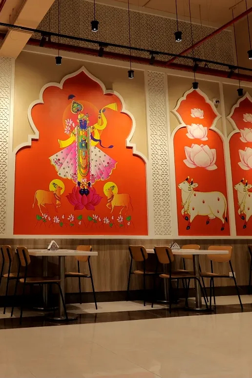 Traditional Indian wall art décor inside Annakoot Restaurant enhancing its spiritual and cultural ambience.