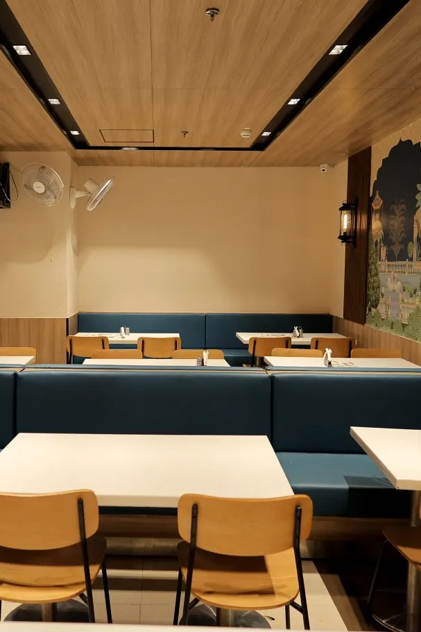 Pure sattvik dining area at Annakoot Vrindavan with serene interior design and modern seating.