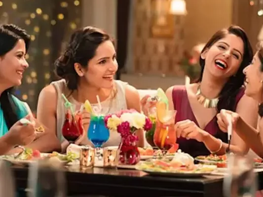 Indian ladies enjoying a kitty party at Annakoot Restaurant with vibrant ambience and fresh sattvik snacks.